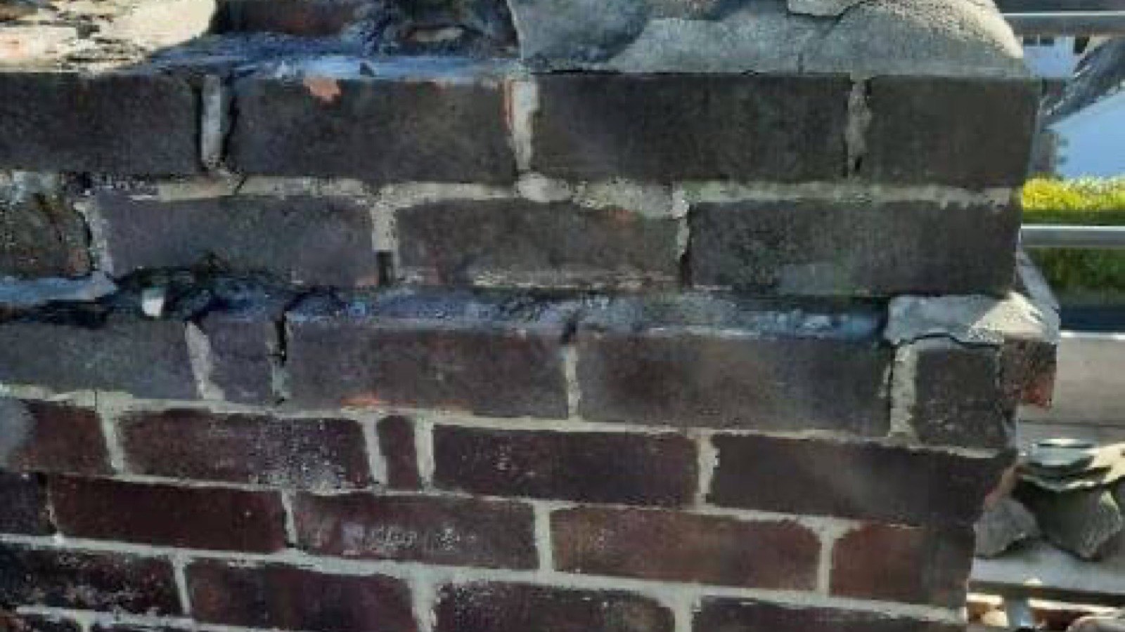 A brick chimney repaired with new lead flashing