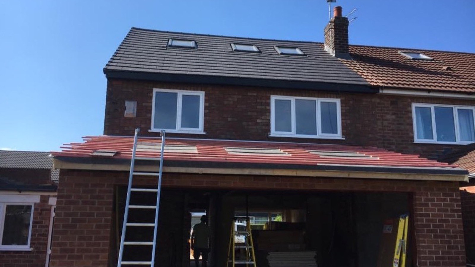 Roofers at work re-roofing a house