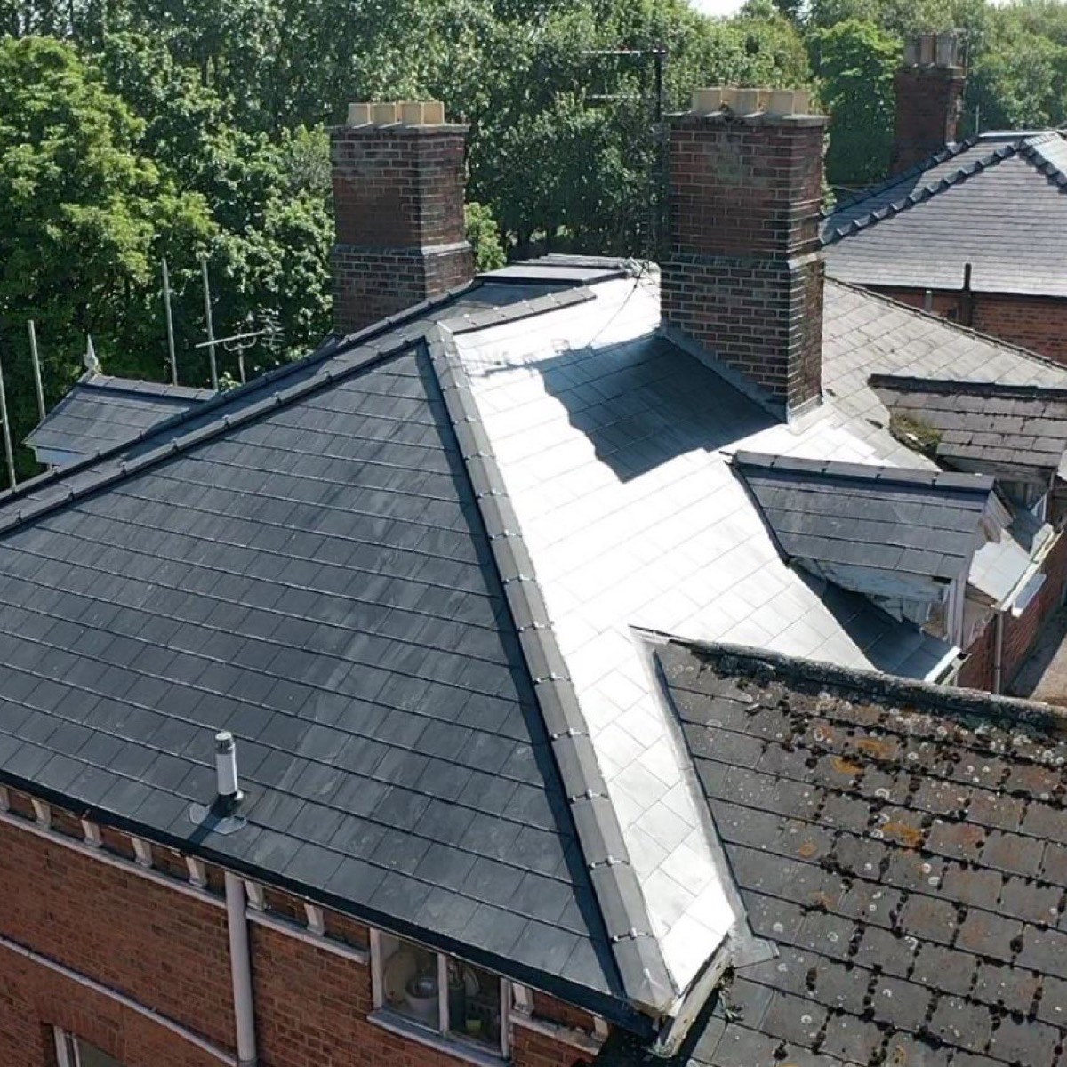 Aerial view of finished slate roofs on terraced houses